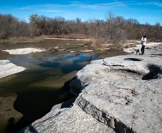 Hiker and dog  at Mckinney Falls Sp TX Onion Creek