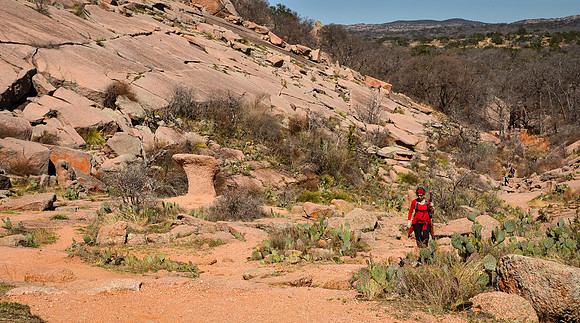Karen hiking the  Echo Canyon Trail at Enchanted Rock State Natu